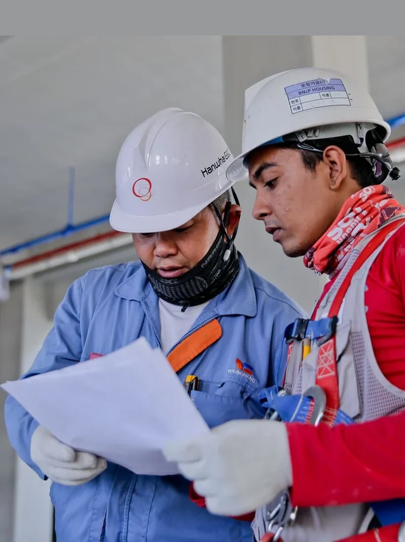 Industrial site workers reviewing project documents